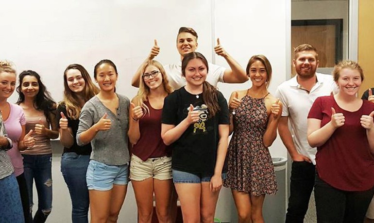 A group of ASU students smile together at HOV