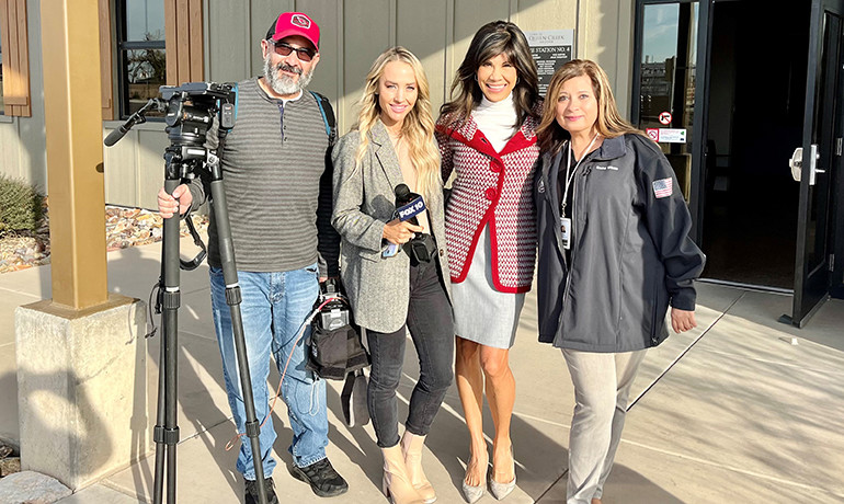 Lin Sue Flood with journalist and cameraman