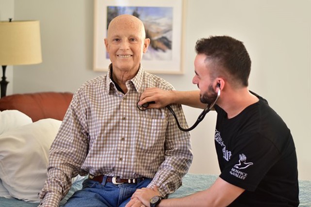 Hospice of the Valley nurse works with a patient.