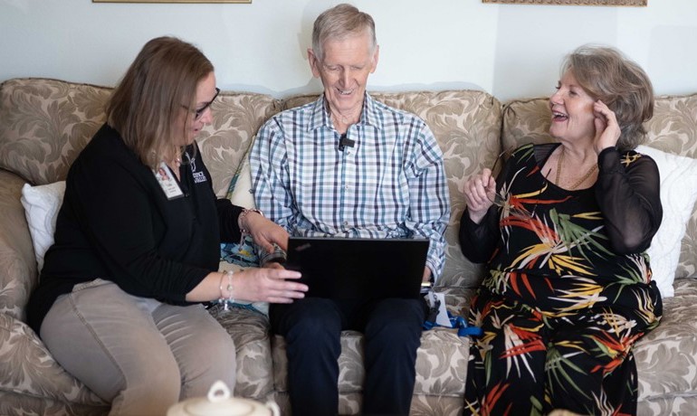 Social worker Callie Dettinger seated on couch with Eamon Treanor and Pat Treanor