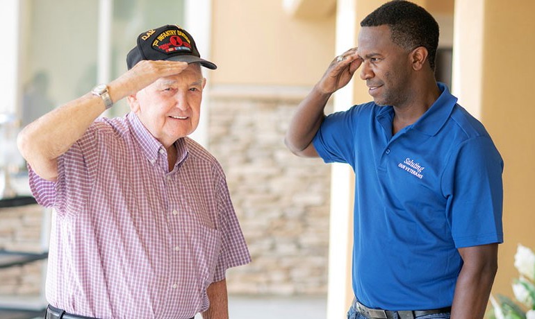 Veteran Kenneth Hamrick and HOV volunteer Ron Garner salute