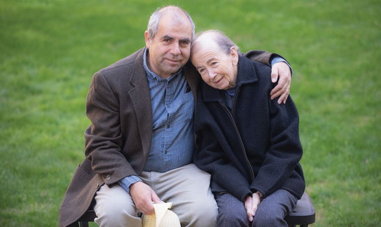 Older man with arm around older woman 