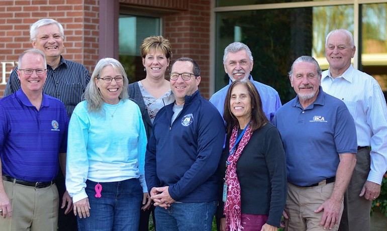 A group of volunteers smile outside HOV