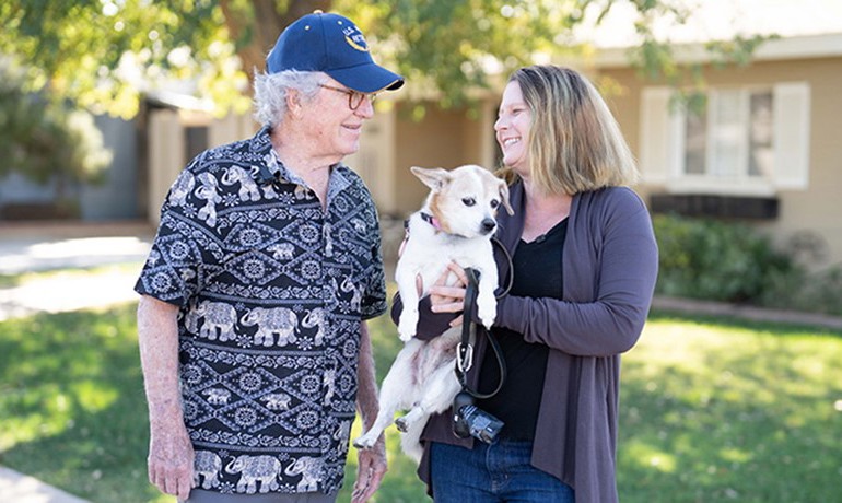 Larry Lambert and Meredith Bartlett holding dog