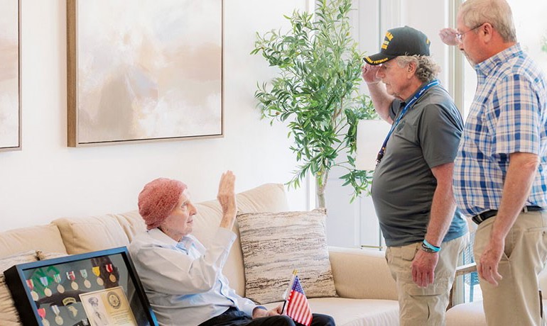 Ned Kent, left, is saluted by Hospice of the Valley volunteer Rodney Dehmer and Kent’s son-in-law, Sam Knott, both Vietnam era veterans.