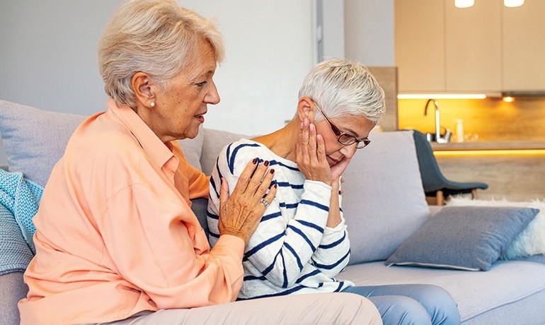 Woman consoles another woman