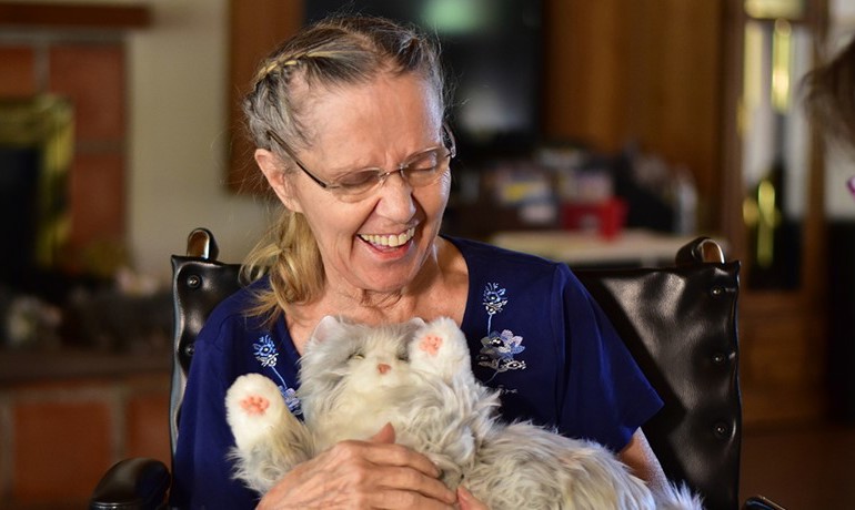 Donna Winston cuddles with her mechanical cat.
