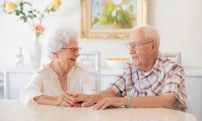 Older couple seated at a table