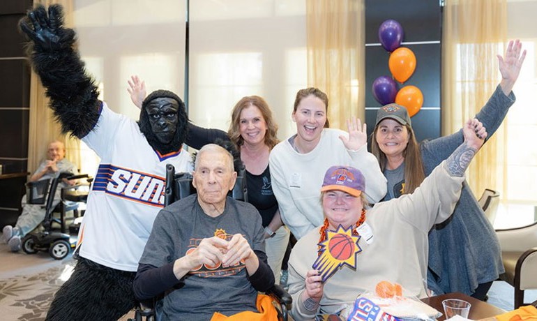 Phoenix suns gorilla mascot poses with HOV employees and patients