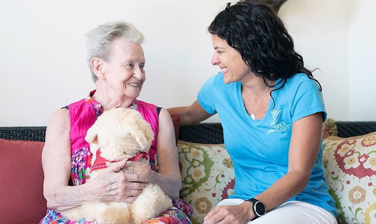 Michelle Bales with patient holding mechanical pet