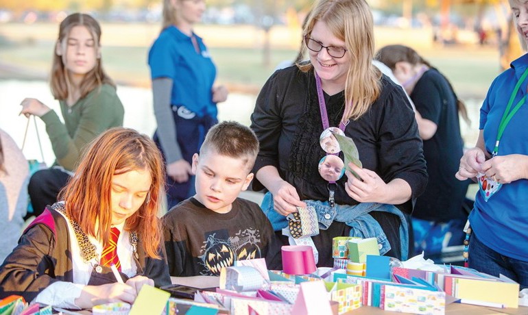 Katherine McKitrick with two children at remembrance event