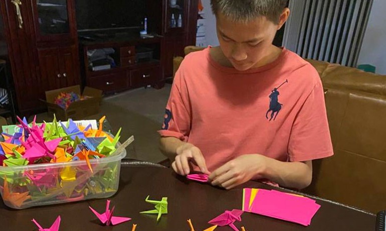 Charles Zhang folding paper cranes