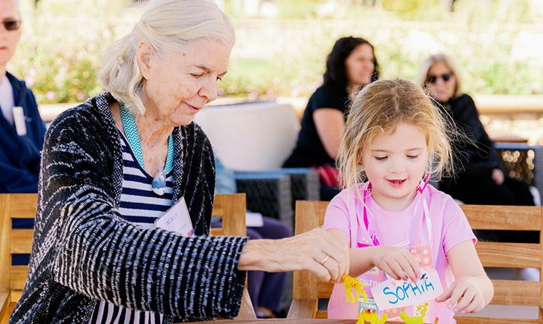 Susan and Sophia entertain each other with toy dinosaurs