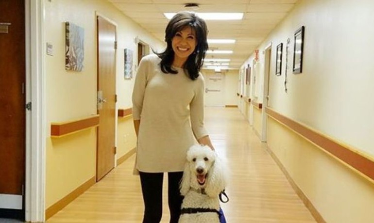 Lin Sue smiles with her dog, Max