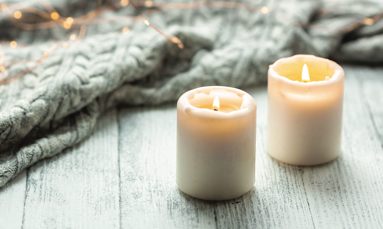 Two white candles on table