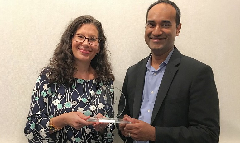 Gobi Paramanandam and Rachel Behrendt pose together with the award