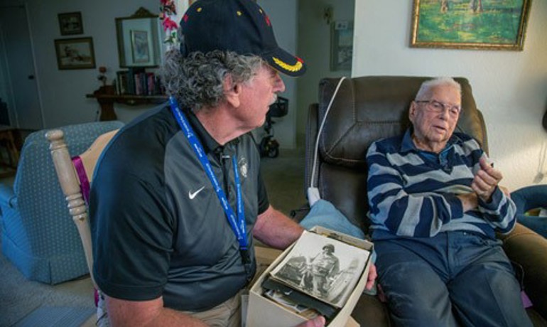 Chester Dorr and Rodney Dehmer look through old photos together